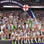 
              England players pose with the trophy after the Women's Euro 2022 final soccer match between England and Germany at Wembley stadium in London, Sunday, July 31, 2022. (AP Photo/Leila Coker)
            