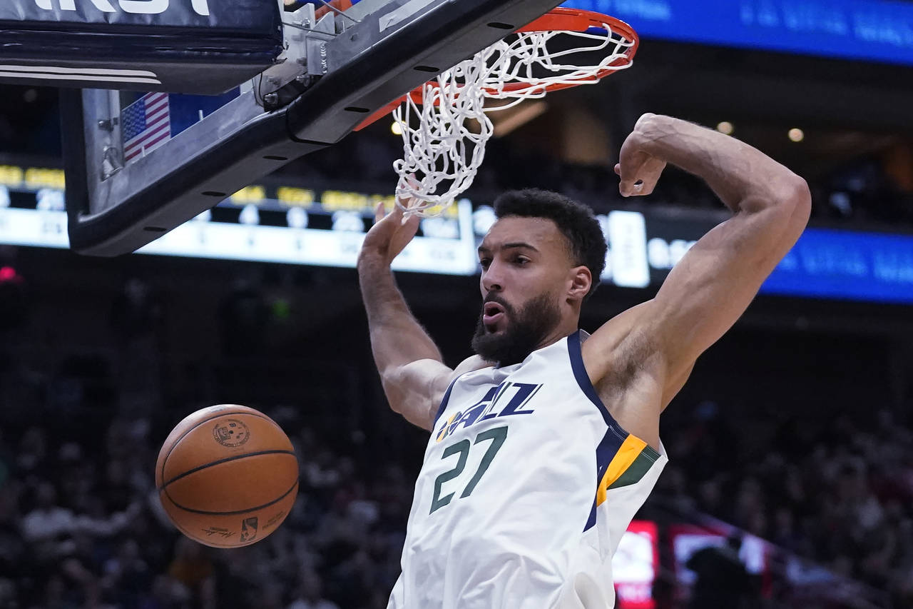FILE - Utah Jazz center Rudy Gobert dunks against the Houston Rockets during the second half of an ...
