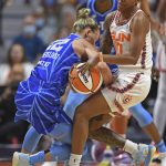 
              Connecticut Sun guard Courtney Williams, right, grapples for the ball with Chicago Sky guard Courtney Vandersloot, left, during a WNBA basketball game in Uncasville, Conn., Sunday, July 31, 2022. (Sean D. Elliot/The Day via AP)
            