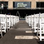 
              Chairs are set up outside the  Jackie Robinson Museum, Tuesday, June 26, 2022, in New York. Long dreamed about and under construction for longer than the big league career of the man it honors, the Jackie Robinson Museum opened Tuesday in Manhattan with a gala ceremony attended by the 100-year-old wife of the barrier-breaking ballplayer and two of his children. (AP Photo/Julia Nikhinson)
            
