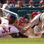 
              St. Louis Cardinals' Dylan Carlson (3) scores past Philadelphia Phillies catcher J.T. Realmuto during the eighth inning of a baseball game Sunday, July 10, 2022, in St. Louis. (AP Photo/Jeff Roberson)
            