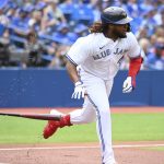 
              Toronto Blue Jays' Vladimir Guerrero Jr. runs out a single off Detroit Tigers starting pitcher Drew Hutchison in the first inning of a baseball game in Toronto, Saturday, July 30, 2022. (Jon Blacker/The Canadian Press via AP)
            