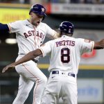 
              Houston Astros' Alex Bregman, left, celebrates his two-run home run against the Seattle Mariners with third base coach Gary Pettis during the first inning of a baseball game Thursday, July 28, 2022, in Houston. (AP Photo/Michael Wyke)
            