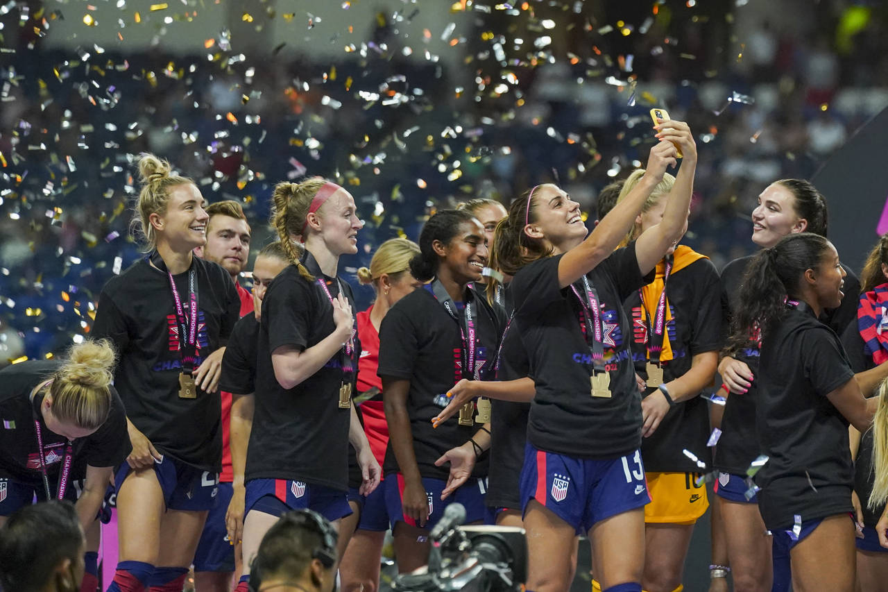 United States' Alex Morgan takes a selfie as she celebrates after winning the CONCACAF Women's Cham...