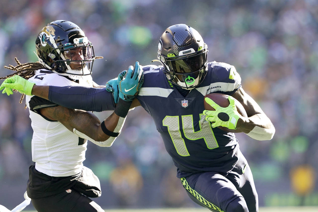 FILE - Seattle Seahawks' DK Metcalf (14) pushes off of Jacksonville Jaguars' Rayshawn Jenkins as he...