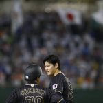 
              FILE - Japan's designated hitter Shohei Ohtani talks with third base coach Takayuki Onishi at third in the seventh inning of an international exhibition series baseball game against Mexico at Tokyo Dome in Tokyo on Nov. 11, 2016. Ohtani of the Los Angeles Angels is arguably the greatest baseball player in the history of the game. His roots are deep in northeastern Japan where he played high school baseball and got his start. (AP Photo/Toru Takahashi, File)
            