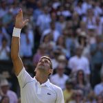 
              Serbia's Novak Djokovic celebrates after beating Britain's Cameron Norrie in a men's singles semifinal on day twelve of the Wimbledon tennis championships in London, Friday, July 8, 2022. (AP Photo/Alastair Grant)
            