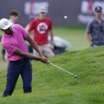 
              Tony Finau hits onto the sixth green during the second round of the Rocket Mortgage Classic golf tournament, Friday, July 29, 2022, in Detroit. (AP Photo/Carlos Osorio)
            