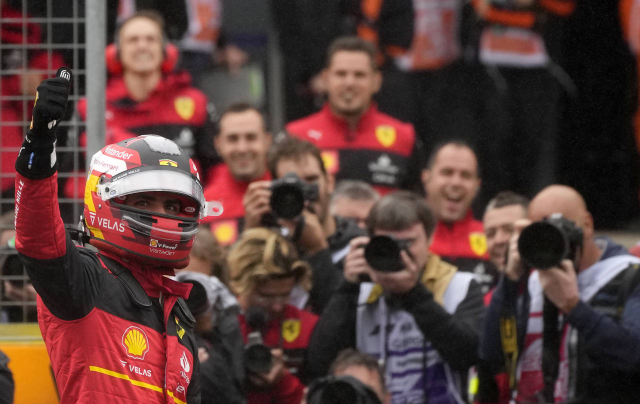 Ferrari driver Carlos Sainz of Spain celebrates after he clocked the fastest time during the qualif...