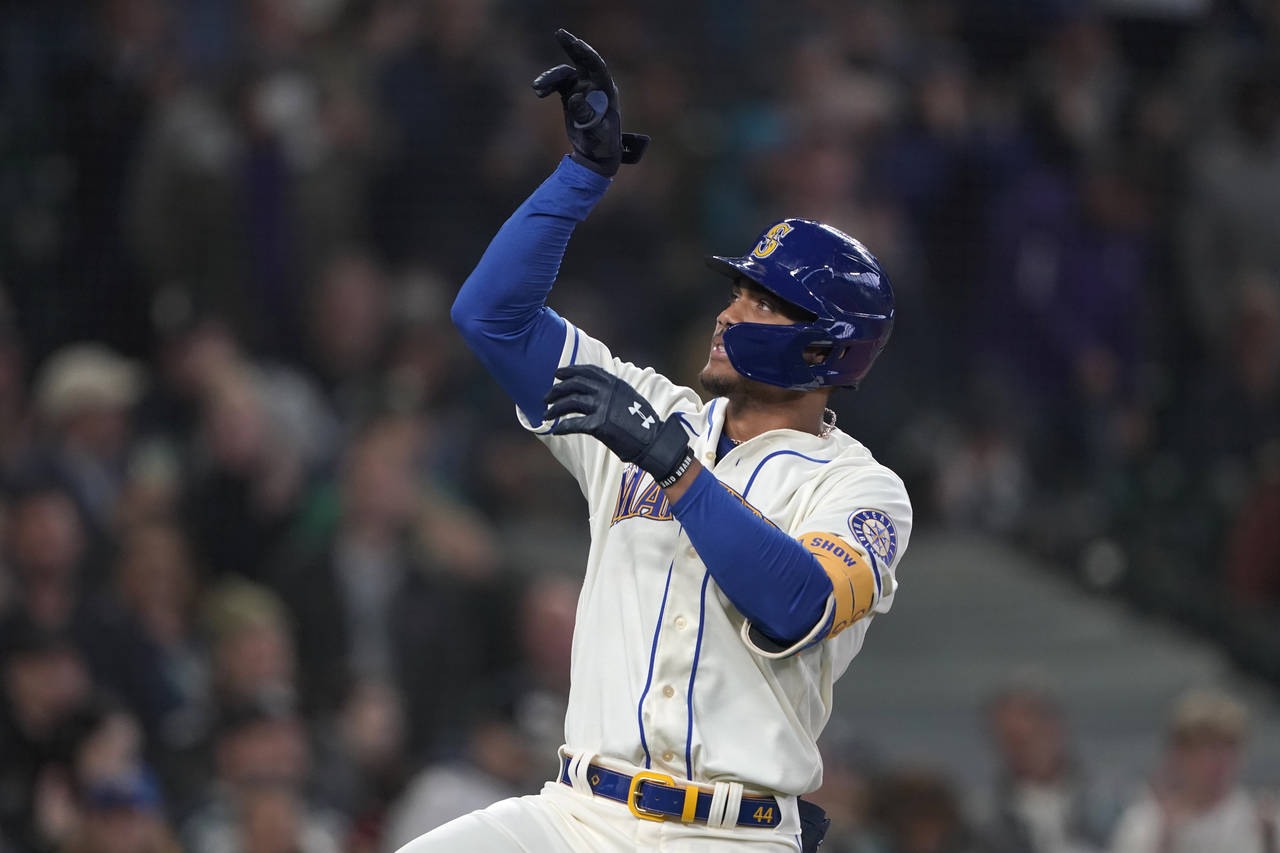 Seattle Mariners' Julio Rodriguez gestures after crossing the plate after he hit a solo home run ag...