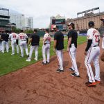 
              Baltimore Orioles players gather on the field after defeating the Los Angeles Angels during a baseball game, Sunday, July 10, 2022, in Baltimore. The Orioles won 9-5 to sweep the series. (AP Photo/Julio Cortez)
            