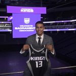 
              Keegan Murray, selected fourth overall by the Sacramento Kings in the NBA basketball draft, displays a team jersey during a news conference in Sacramento, Calif., Saturday, June 25, 2022. (AP Photo/Rich Pedroncelli)
            