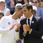 
              Serbia's Novak Djokovic and Switzerland's Roger Federer speak during a 100 years of Centre Court celebration on day seven of the Wimbledon tennis championships in London, Sunday, July 3, 2022. (AP Photo/Kirsty Wigglesworth)
            