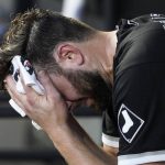 
              Chicago White Sox starting pitcher Lucas Giolito looks down as he wipes his face in the dugout during the first inning of a baseball game against the Cleveland Guardians in Chicago, Friday, July 22, 2022. (AP Photo/Nam Y. Huh)
            
