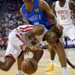 
              Houston Rockets' Trhae Mitchell (40) drives the ball against Oklahoma City Thunder's Ousmane Dieng (13) during the first half an NBA summer league basketball game Saturday, July 9, 2022, in Las Vegas. (AP Photo/David Becker)
            