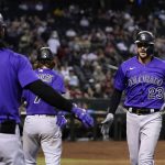 
              Colorado Rockies' Kris Bryant (23) celebrates his home run against the Arizona Diamondbacks with Brendan Rodgers (7) and Connor Joe (9) during the seventh inning of a baseball game Friday, July 8, 2022, in Phoenix. (AP Photo/Ross D. Franklin)
            
