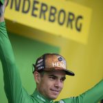 
              Belgium's Wout Van Aert, wearing the best sprinter's green jersey, celebrates on the podium after the third stage of the Tour de France cycling race over 182 kilometers (113 miles) with start in Vejle and finish in Sonderborg, Denmark, Sunday, July 3, 2022. (AP Photo/Daniel Cole)
            