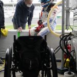 
              FILE - Robert Wickens, right, talks with physical trainer Jim Leo before taking a turn driving during practice for the Rolex 24 hour auto race at Daytona International Speedway, Thursday, Jan. 27, 2022, in Daytona Beach, Fla. Wickens used hand controls last weekend to win his first race since a 2018 spinal cord injury temporarily ended his racing career. Across an ocean, former IndyCar driver Sam Schmidt and motorcycle racer Wayne Rainey also piloted vehicles during the annual Goodwood Festival of Speed in England. (AP Photo/John Raoux, File)
            