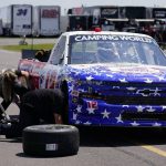 
              Crew members work on the truck of Spencer Boyd before practice for Saturday's NASCAR Truck Series auto race at Pocono Raceway, Friday, July 22, 2022, in Long Pond, Pa. (AP Photo/Matt Slocum)
            