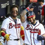 
              Atlanta Braves outfielder Eddie Rosario celebrates his solo homer with Ronald Acuna in the dugout during the fifth inning of a baseball game against the St. Louis Cardinals Wednesday, July 6, 2022, in Atlanta. (Curtis Compton/Atlanta Journal-Constitution via AP)
            