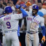 
              New York Mets' Brandon Nimmo (9) is congratulated by Starling Marte (6) after Nimmo hit a home run scoring Eduardo Escobar, during the eighth inning of a baseball game against the Miami Marlins, Friday, July 29, 2022, in Miami. (AP Photo/Wilfredo Lee)
            