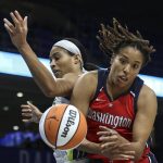 
              Dallas Wings forward Isabelle Harrison, left, and Washington Mystics forward Tianna Hawkins try to get control of the ball during the first half of a WNBA basketball game Thursday, July 28, 2022, in Arlington, Texas. (Rebecca Slezak/The Dallas Morning News via AP)
            