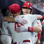 
              Philadelphia Phillies' J.T. Realmuto, right, hugs Yairo Munoz after hitting a two-run home run during the fourth inning of a baseball game against the Miami Marlins, Saturday, July 16, 2022, in Miami. (AP Photo/Lynne Sladky)
            
