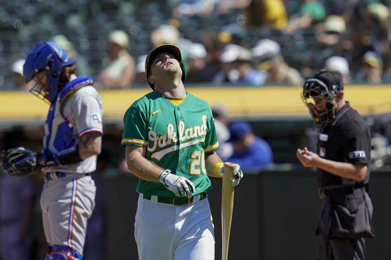 Oakland Athletics' Sheldon Neuse (26) reacts after striking out against Texas Rangers starting pitc...