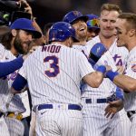 
              New York Mets catcher Tomas Nido (3) and center fielder Brandon Nimmo, center right, celebrate with their teammates after Nimmo reaches on an infield fielding error to allow the game-winning run by Nido in the tenth inning of a baseball game against the Miami Marlins, Saturday, July 9, 2022, in New York. (AP Photo/John Minchillo)
            