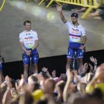
              Slovakia's sprinter Peter Sagan, right, and other riders of Team TotalEnergies line up during the team presentation ahead of the Tour de France cycling race in Copenhagen, Denmark, Wednesday, June 29, 2022. The race starts Friday, July 1, the first stage is an individual time trial over 13.2 kilometers (8.2 miles) with start and finish in Copenhagen. (AP Photo/Daniel Cole)
            