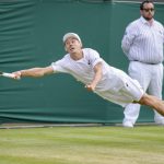 
              Australia's Alex De Minaur reaches out to return the ball to Chile's Cristian Garin during a men's singles fourth round match on day eight of the Wimbledon tennis championships in London, Monday, July 4, 2022. (AP Photo/Kirsty Wigglesworth)
            