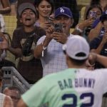 
              Fans take photos for rapper and singer Bad Bunny during the MLB All Star Celebrity Softball game, Saturday, July 16, 2022, in Los Angeles. (AP Photo/Mark J. Terrill)
            