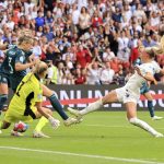
              England's Chloe Kelly scores her side's second goal during the Women's Euro 2022 final soccer match between England and Germany at Wembley stadium in London, Sunday, July 31, 2022. (AP Photo/Leila Coker)
            