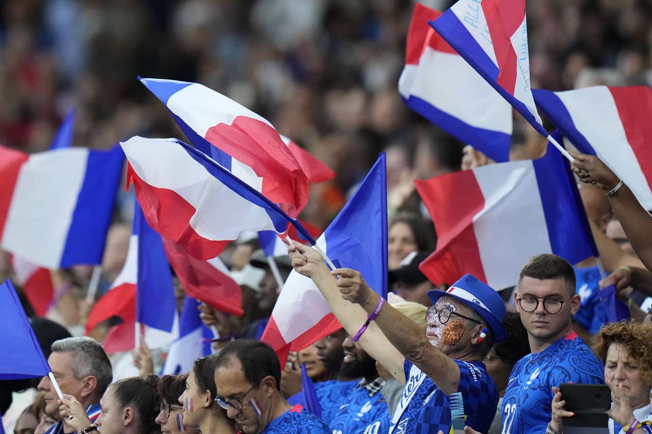 France supporters wave flags during the Women Euro 2022 semifinal soccer match between Germany and ...
