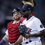 
              Boston Red Sox's Jackie Bradley Jr., right, walks to the dugout with Christian Vazquez after pitching during the ninth inning of the team's baseball game against the New York Yankees, Friday, July 8, 2022, in Boston. (AP Photo/Michael Dwyer)
            