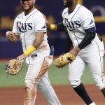 
              Tampa Bay Rays' Harold Ramirez, left, reacts with teammate Yandy Diaz after defeating the Boston Red Sox in a baseball game Monday, July 11, 2022, in St. Petersburg, Fla. (AP Photo/Scott Audette)
            