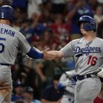 
              Los Angeles Dodgers' Will Smith (16) is congratulated by teammate Freddie Freeman (5) after hitting a two-run home run during the seventh inning of a baseball game against the St. Louis Cardinals Wednesday, July 13, 2022, in St. Louis. (AP Photo/Jeff Roberson)
            