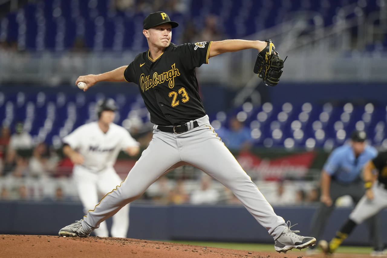 Pittsburgh Pirates starting pitcher Mitch Keller (23) aims a pitch during the first inning of a bas...