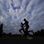 
              Joohan Oh, of South Korea, and Dario Castro, of Mexico, compete during the men's marathon at the World Athletics Championships Sunday, July 17, 2022, in Eugene, Ore. (AP Photo/Gregory Bull)
            