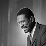 
              FILE - Bill Russell grins at announcement that he had been named coach of the Boston Celtics basketball team, April 18, 1966. The NBA great Bill Russell has died at age 88. His family said on social media that Russell died on Sunday, July 31, 2022. Russell anchored a Boston Celtics dynasty that won 11 titles in 13 years. (AP Photo, File)
            