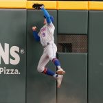 
              New York Mets center fielder Brandon Nimmo (9) makes a catch at the wall to retire Atlanta Braves' Dansby Swanson in the third inning of a baseball game Tuesday, July 12, 2022, in Atlanta. (AP Photo/John Bazemore)
            