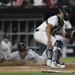 
              Detroit Tigers' Jonathan Schoop scores on a Jeimer Candelario single while Chicago White Sox catcher Seby Zavala waits for the throw during the sixth inning of a baseball game Friday, July 8, 2022, in Chicago. (AP Photo/Paul Beaty)
            