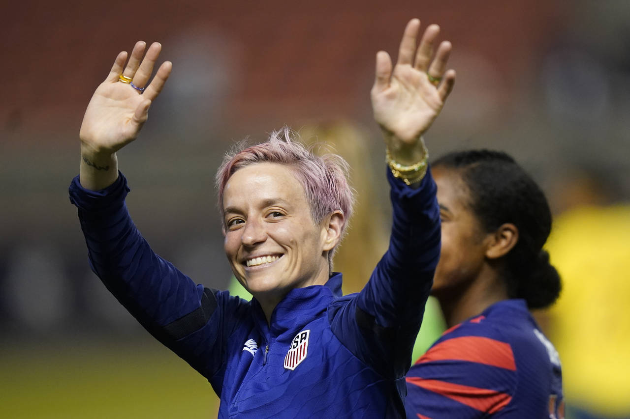FILE - Megan Rapinoe waves to fans following the team's international friendly soccer match against...