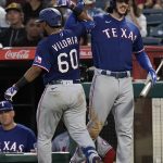 
              Texas Rangers' Meibrys Viloria, left, celebrates his two-run home run against the Los Angeles Angels with Jonah Heim during the sixth inning of a baseball game Saturday, July 30, 2022, in Anaheim, Calif. (AP Photo/Jae C. Hong)
            