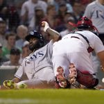 
              Tampa Bay Rays' Randy Arozarena slides into home on a single by Rene Pinto as Boston Red Sox catcher Christian Vazquez loses the ball during the sixth inning of a baseball game at Fenway Park, Tuesday, July 5, 2022, in Boston. (AP Photo/Mary Schwalm)
            