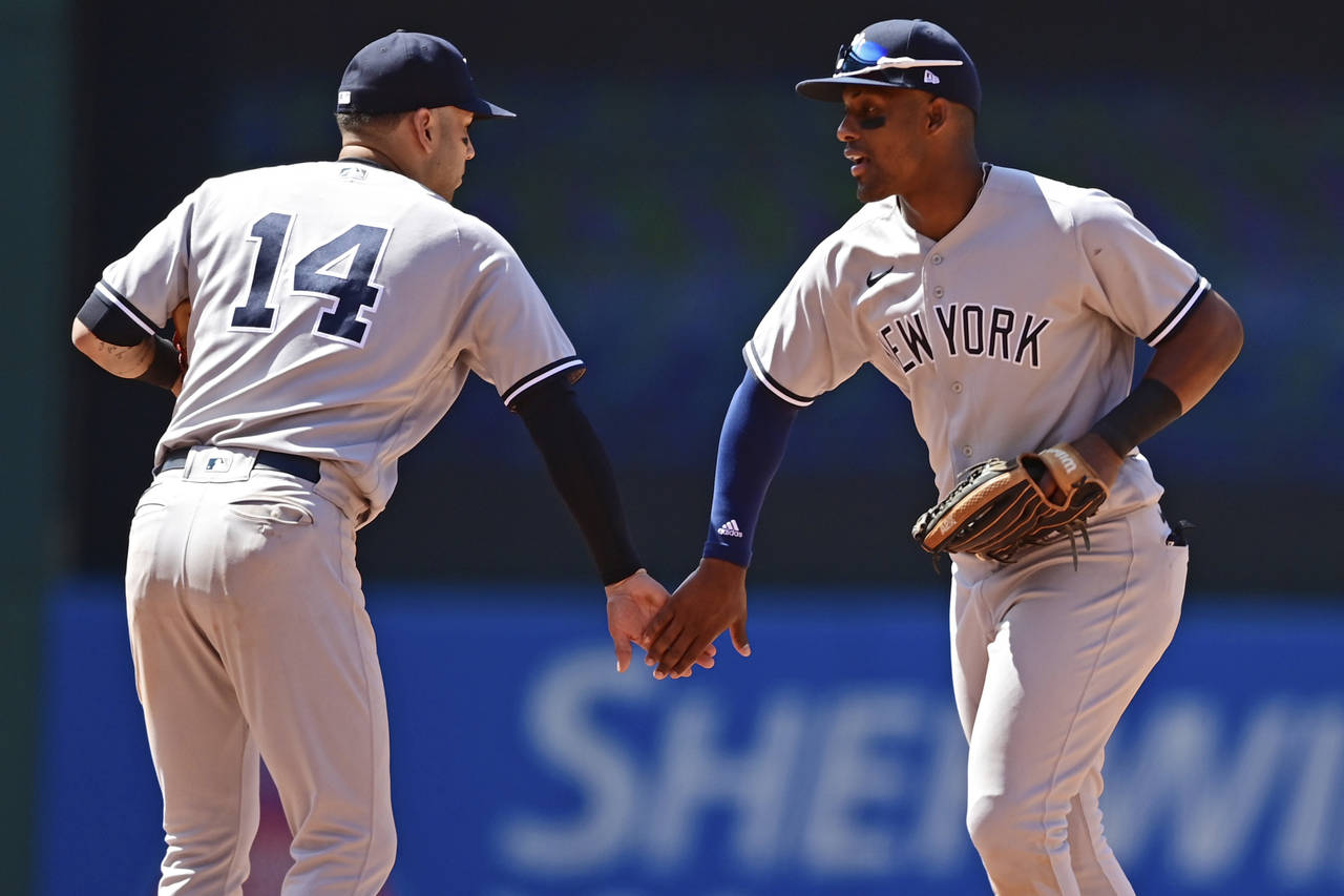 New York Yankees left fielder Miguel Andujar, right, is congratulated by shortstop Marwin Gonzalez ...