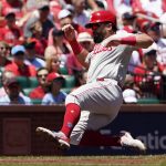 
              Philadelphia Phillies' Kyle Schwarber scores during the first inning of a baseball game against the St. Louis Cardinals Sunday, July 10, 2022, in St. Louis. (AP Photo/Jeff Roberson)
            