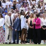 
              Venus Williams takes a photo standing between U.S. tennis legend Billie Jean King and Rod Laver during a 100 years of Centre Court celebration on day seven of the Wimbledon tennis championships in London, Sunday, July 3, 2022. (AP Photo/Kirsty Wigglesworth)
            