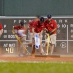 
              Members of the Boston Red Sox grounds crew tend to the field during the ninth inning of the team's baseball game against the Tampa Bay Rays at Fenway Park, Tuesday, July 5, 2022, in Boston. (AP Photo/Mary Schwalm)
            