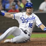 
              Kansas City Royals' Andrew Benintendi slides across home plate to score against the Detroit Tigers during the eighth inning of a baseball game, Tuesday, July 12, 2022, in Kansas City, Mo. (AP Photo/Reed Hoffmann)
            